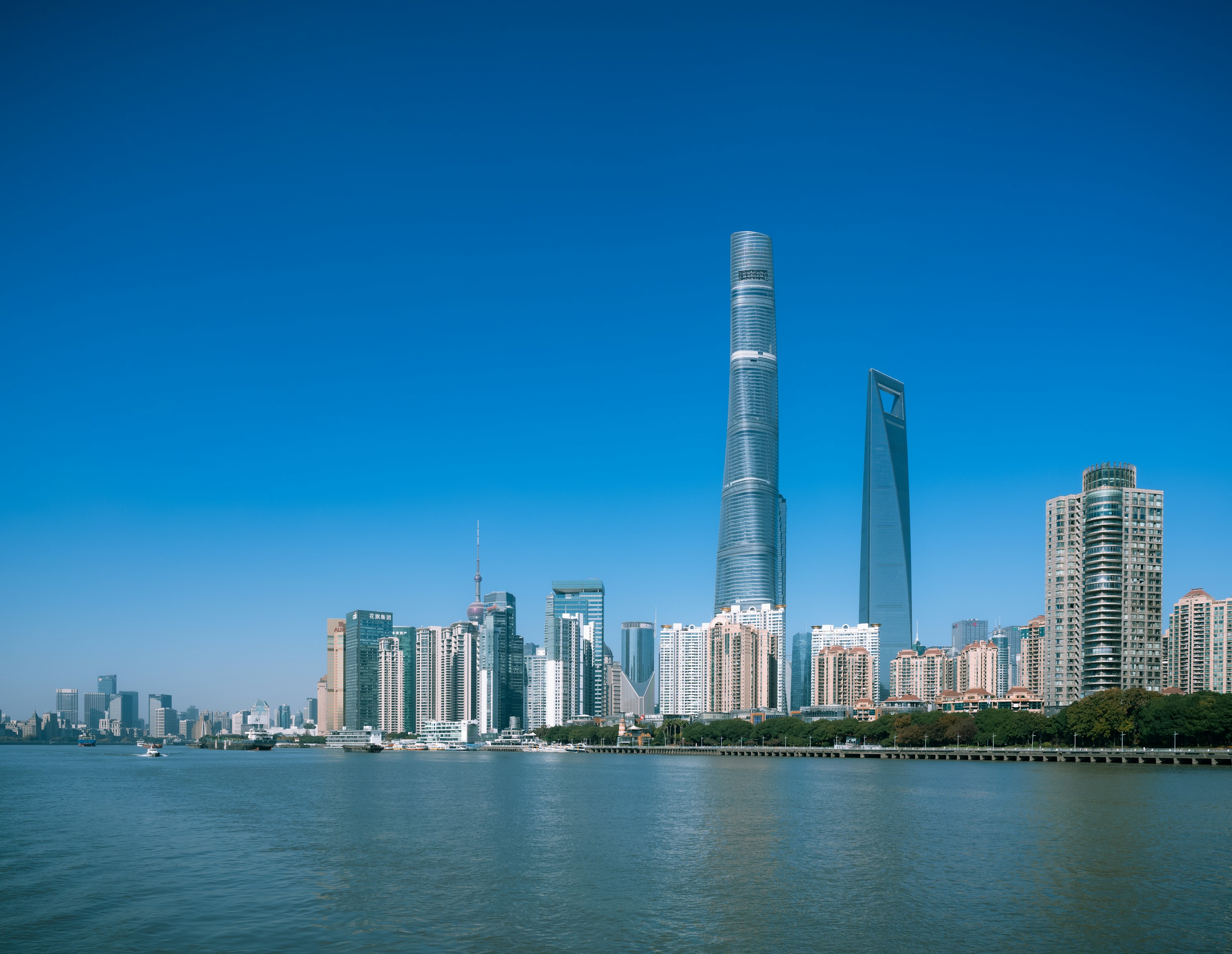 Modern Shanghai skyline and waterfront under a clear blue sky